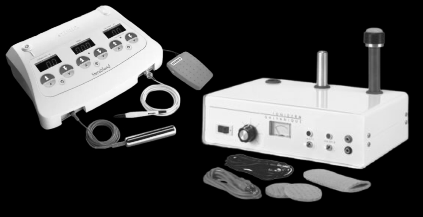 Medical electrotherapy equipment set: control unit with cables, pads, and handheld applicators on a black background.