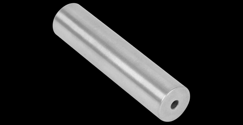 Silver metal cylindrical pin with a through-hole at one end on a black background (informative).