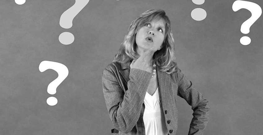A businesswoman in a blazer with hand on chin, surrounded by large question marks, showing confusion or indecision.